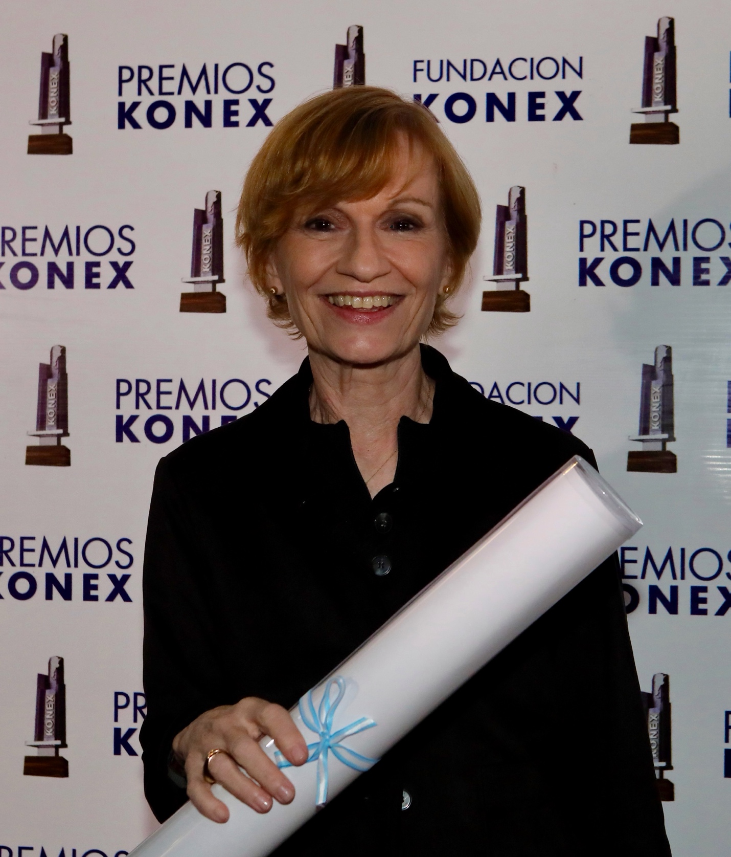 Dr. Arleen Salles holding her 2026 Premio Konex Diploma al Mérito